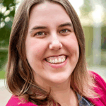 A white woman with long brown hair smiles